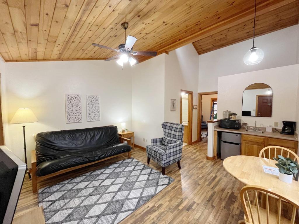 a living room with a couch and a table at Columbine B Cabin Suite in Woodland Park