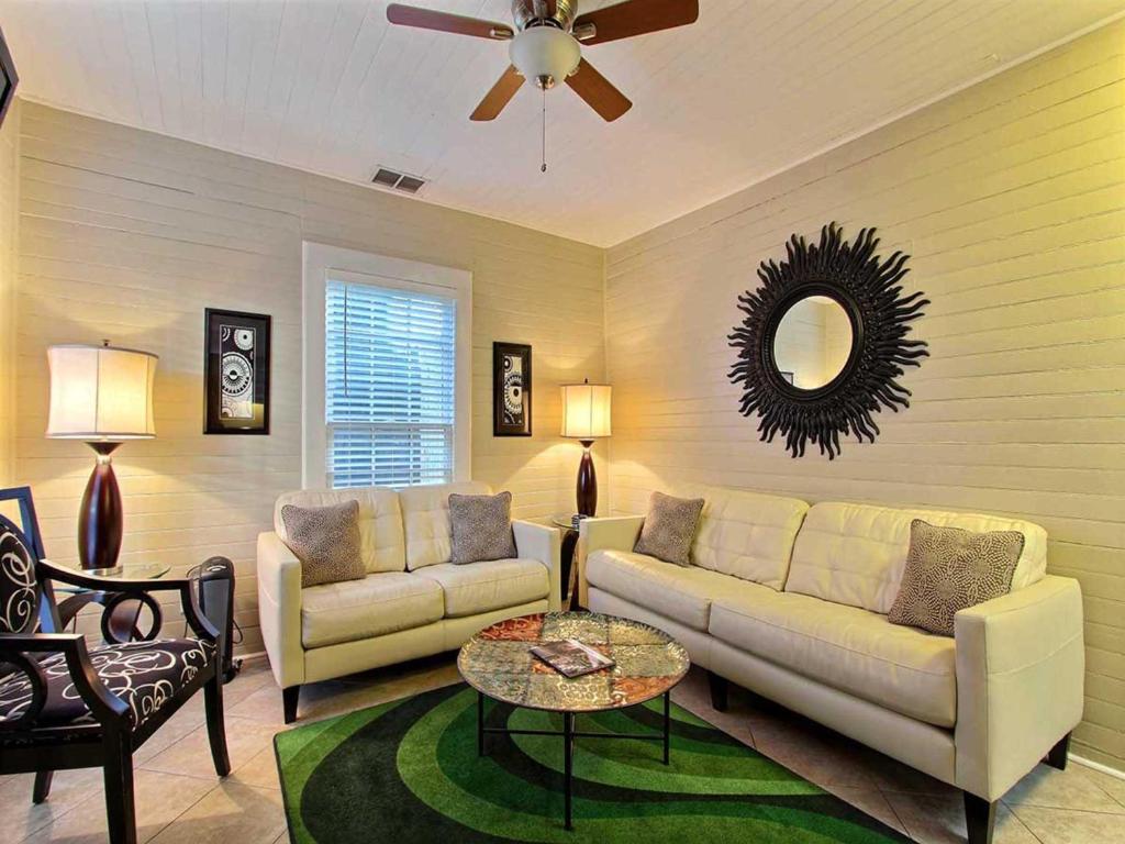 - un salon avec un canapé et une table dans l'établissement Forsyth Park West Carriage House, à Savannah