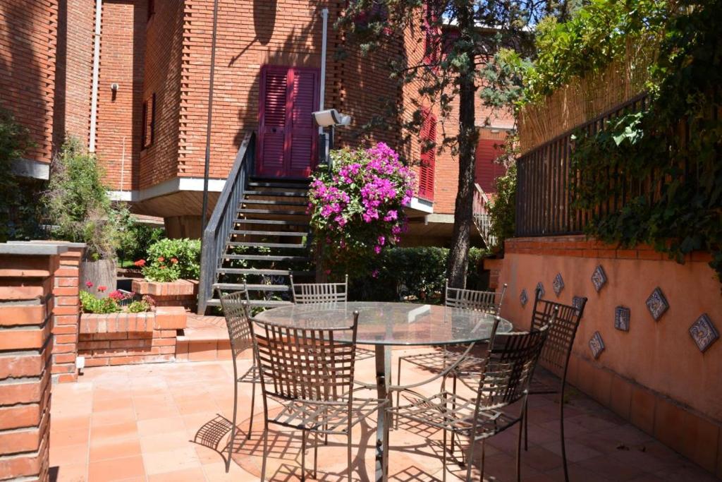 a patio with a table and chairs and a staircase at Villa Louise by Holiday World in Aci Castello
