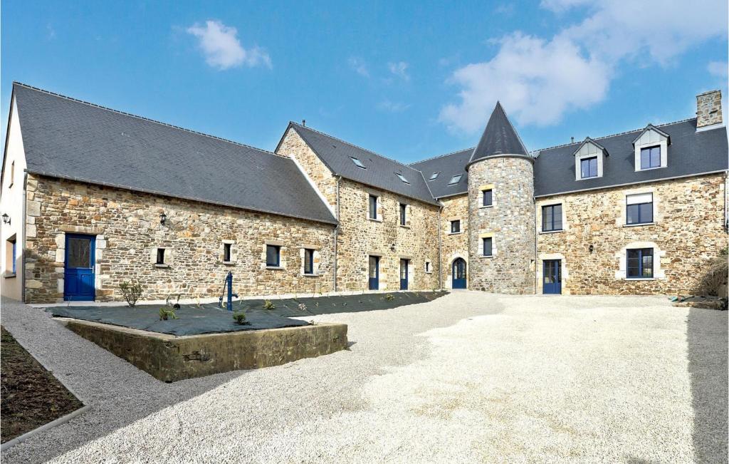 a large stone building with a large courtyard at 4 Bedroom Stunning Home In Fierville-les-mines in Fierville-les-Mines