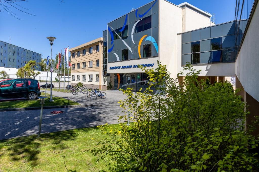 a building with a car parked in front of it at Gdańska Szkoła Szermierki in Gdańsk