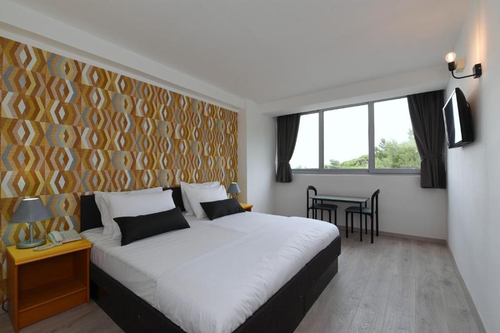Postel nebo postele na pokoji v ubytování Hotel Tolero