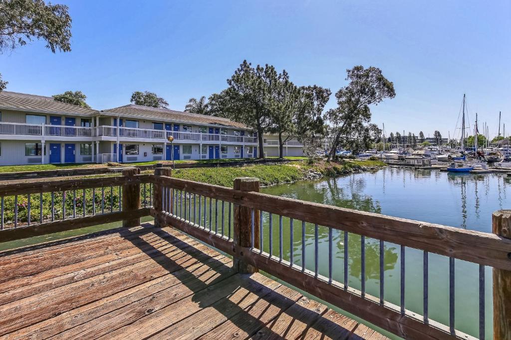 a wooden bridge over a body of water with a marina at Motel 6-Oakland, CA - Embarcadero in Oakland