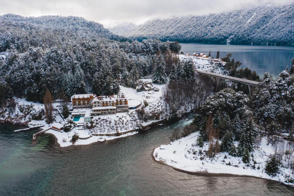 an aerial view of a resort in the snow at Correntoso Lake & River Hotel in Villa La Angostura