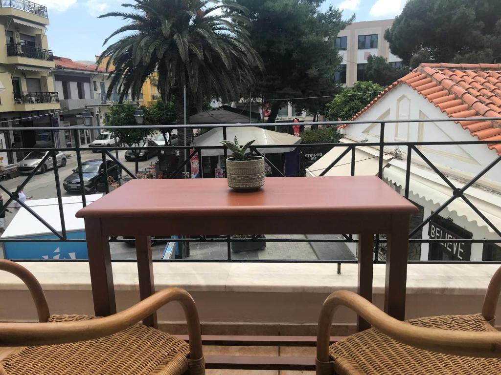 a small table and two chairs on a balcony at Theros Apartments in Myrina