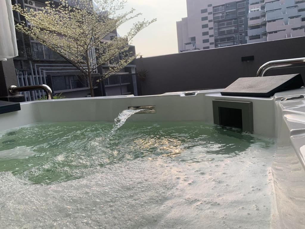 a bath tub with water coming out of it at lmperio Residence Melaka - Private Indoor Hot Jacuzzi in Melaka