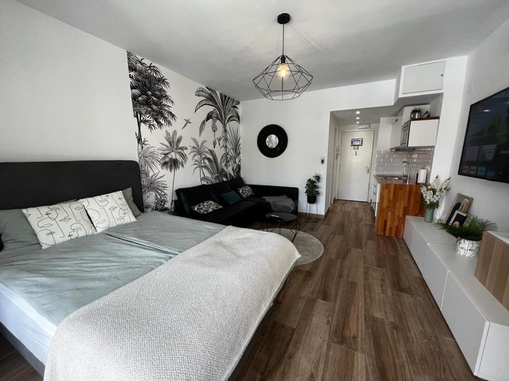 a bedroom with a bed and a living room at Lux Apartment BY NAMASTE ELITE in Torremolinos