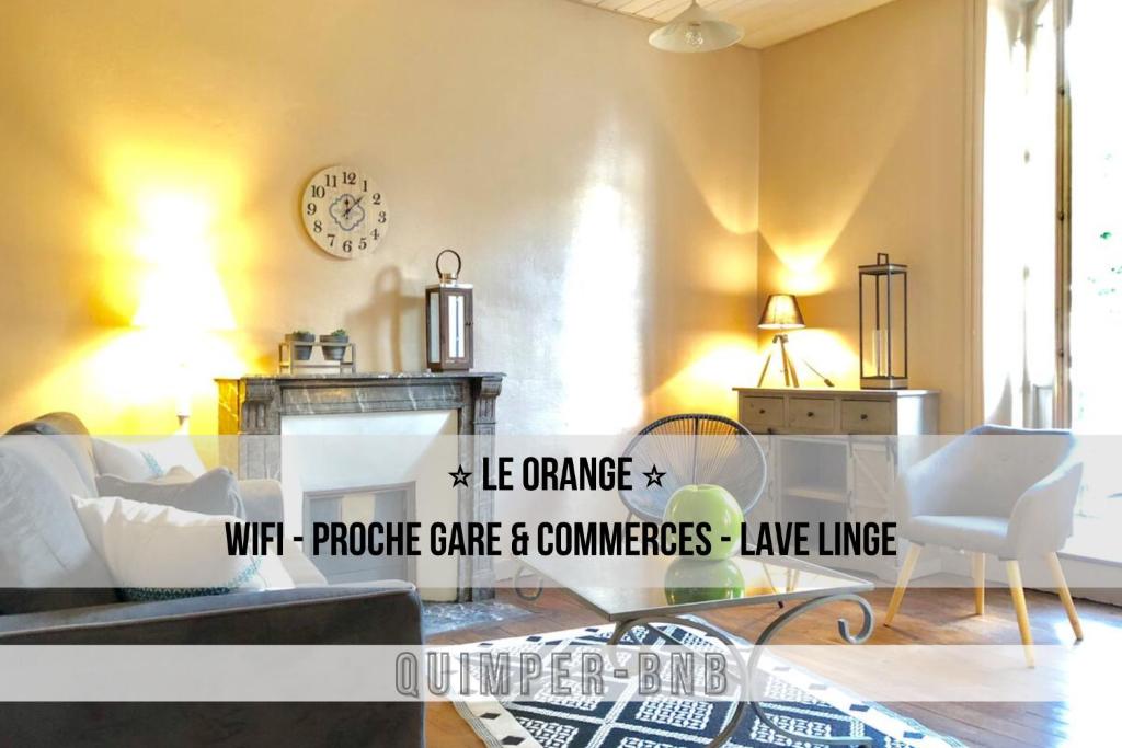 a living room with a couch and a table at LE ORANGE - Confort - Wifi - Entre Gare et Centre in Quimper