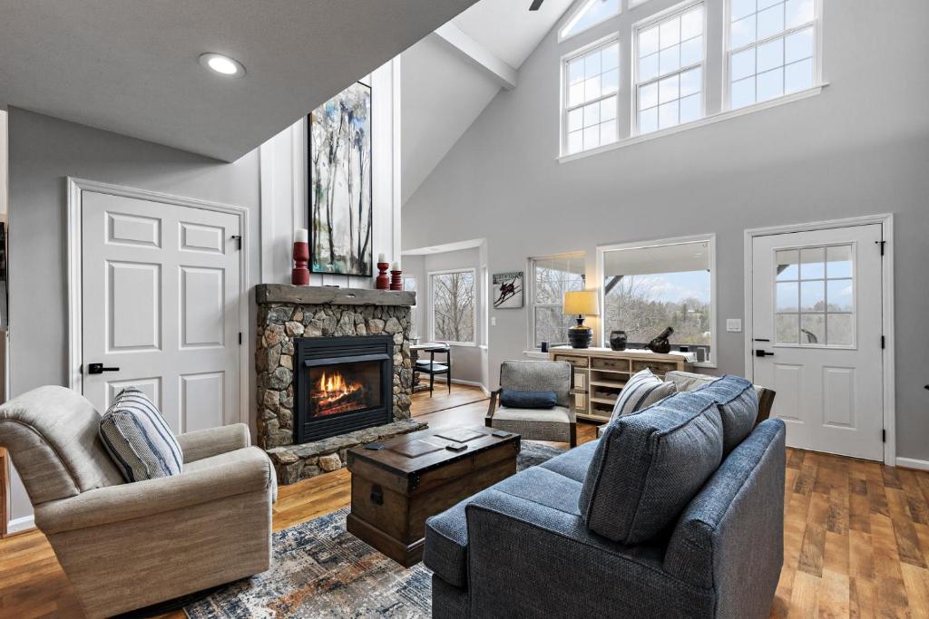 a living room with two couches and a fireplace at Stairway to Heaven in Blowing Rock