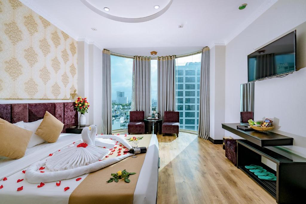 a hotel room with a bed with a large window at Adina 3 Star Hotel in Danang