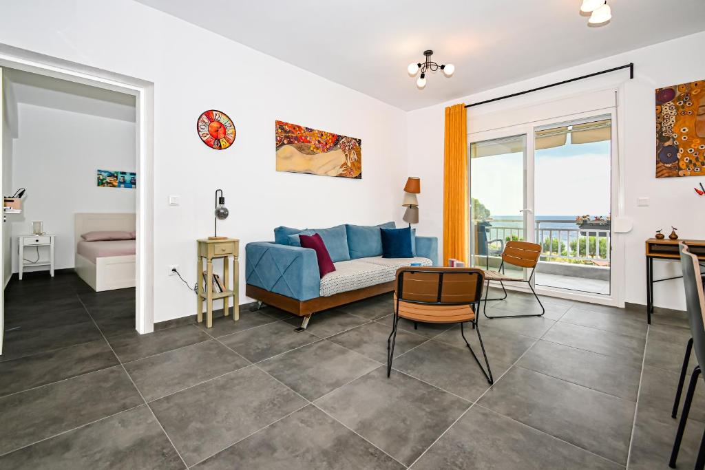 a living room with a couch and a table at E & D family apartment by the sea in Kalives Poligirou