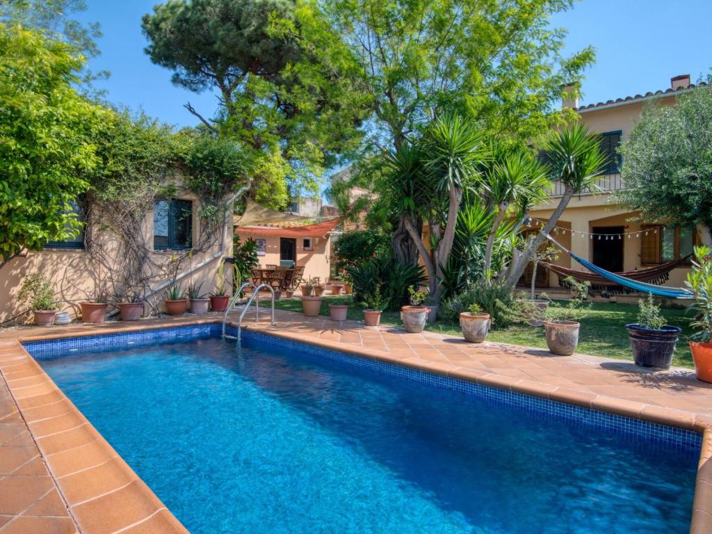 a swimming pool in front of a house with trees at Casa Villa Palafrugell 1506 in Palafrugell