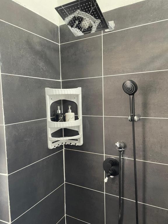 a bathroom with a shower with a shower head at Camera in centro storico in Olbia
