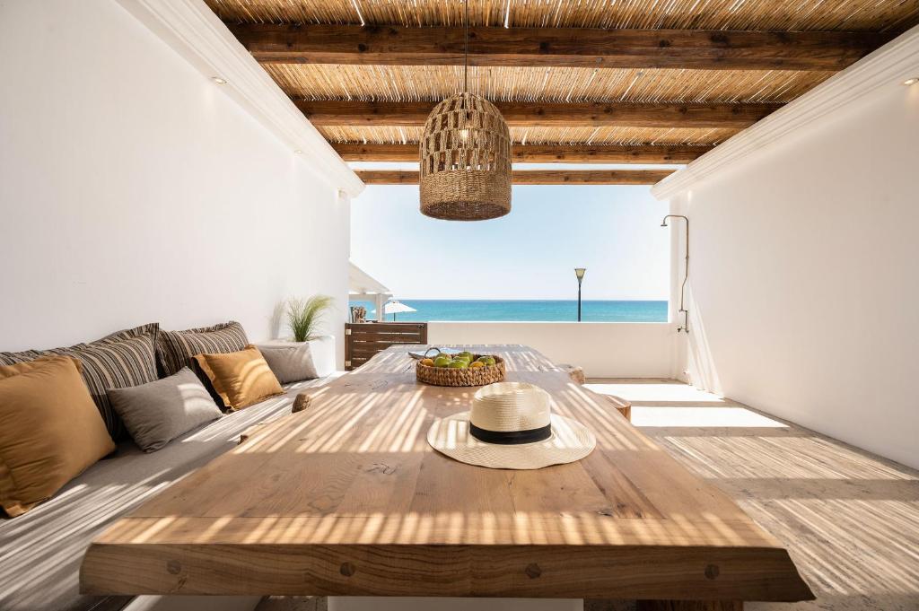 a living room with a table and a view of the ocean at Euphoria Suites and Spa in Kardamaina