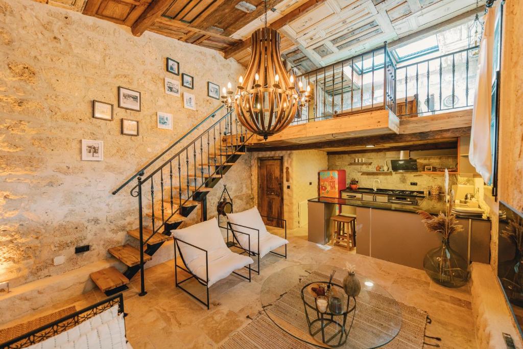 a large kitchen with a spiral staircase in a loft at Suare Alaçatı Adults Only in Alaçatı