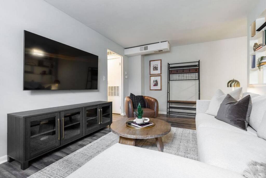 a living room with a white couch and a flat screen tv at Maple Heights Retreat in Maple Heights