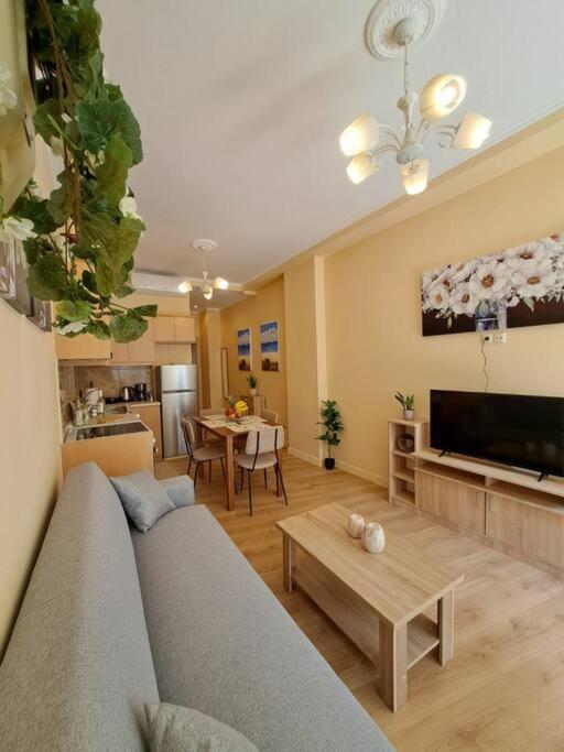 a living room with a couch and a table at Corfu Town Cozy Apartment in Ágios Rókkos