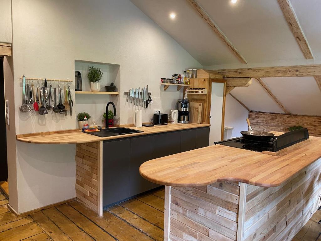 a kitchen with a wooden counter top in a room at Backyard Mountain Hostel in Mayrhofen