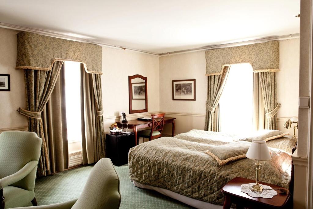 Postel nebo postele na pokoji v ubytování Hotel Kong Carl - Unike Hoteller