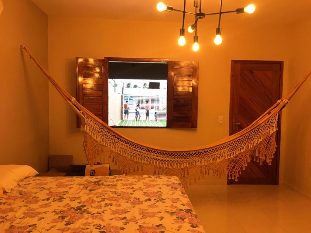 a bedroom with a hammock in a room at Casa de praia - Trairí CE in Trairi
