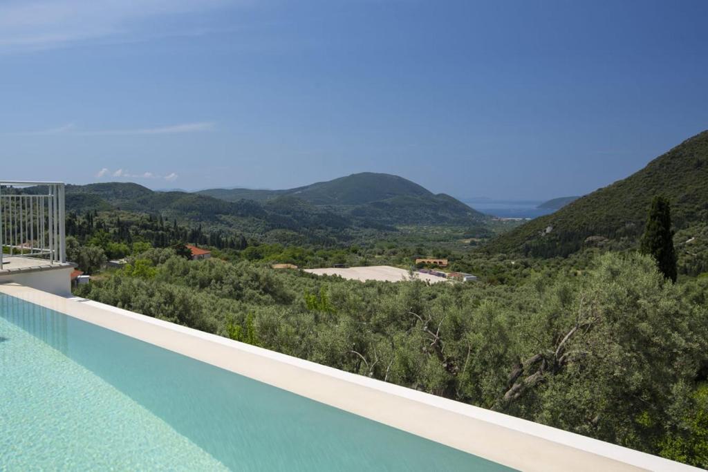 a swimming pool with a view of the mountains at Panoutsis Villa Vista in Sívros