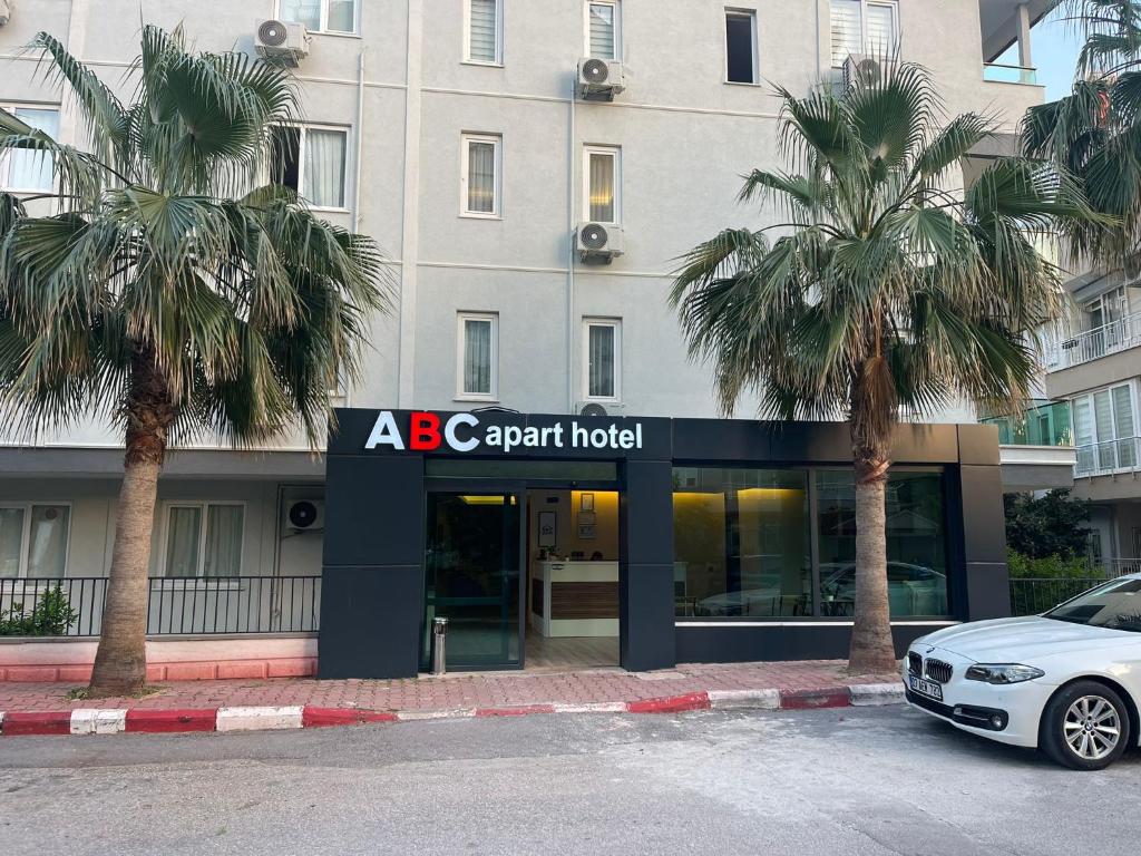 een auto geparkeerd voor een appartementenhotel bij ABC Apart Hotel in Antalya