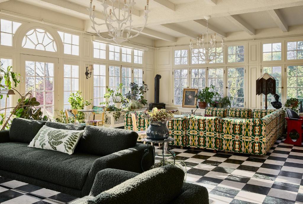 a large living room with couches and a chandelier at Blind Tiger Burlington in Burlington