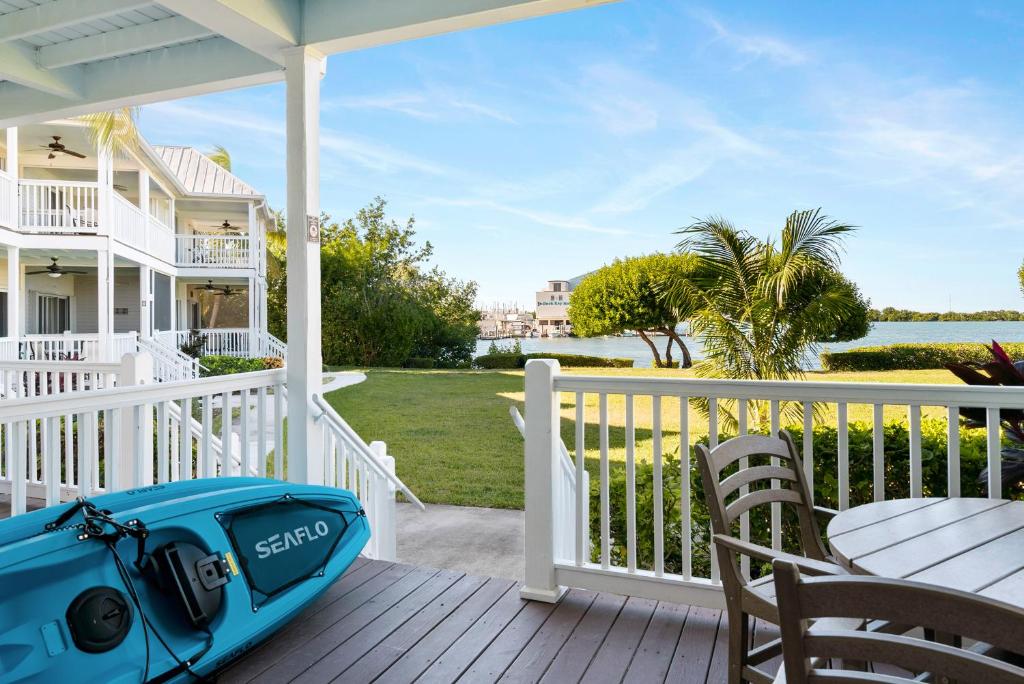 a patio with a table and a bag on a porch at Beach House Getaway in Duck Key
