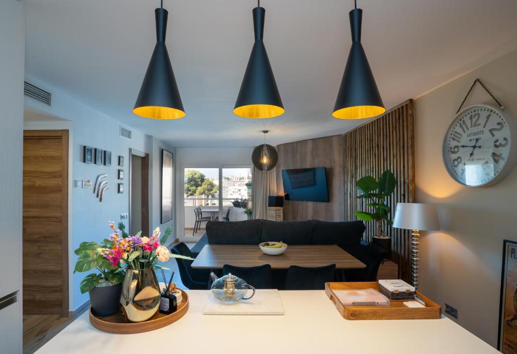 ein Wohnzimmer mit einem Sofa und einem Tisch in der Unterkunft Los Riscos Luxury Apartment - Torremolinos in Torremolinos