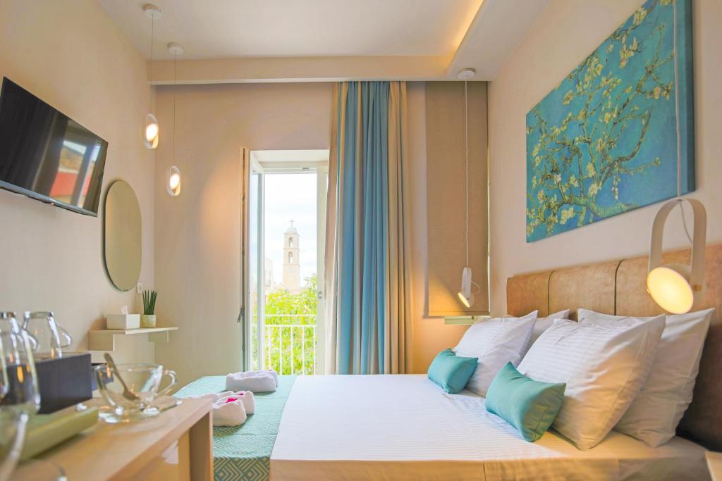 a bedroom with a large bed with a window at Casa De Potie in Chania Town
