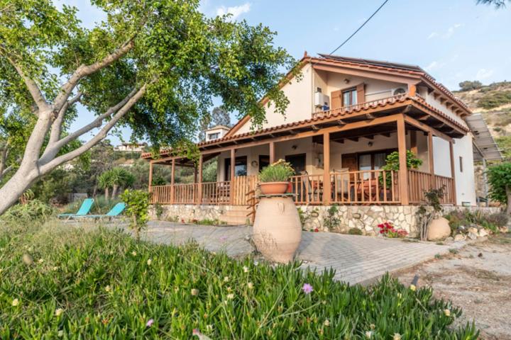 a house with a large porch and a balcony at Villa Sofita in Pitsidia