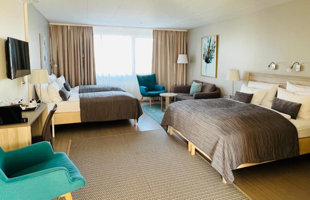 Pokój hotelowy z dużym łóżkiem i kanapą w obiekcie Hótel Fransiskus Stykkishólmi w mieście Stykkishólmur