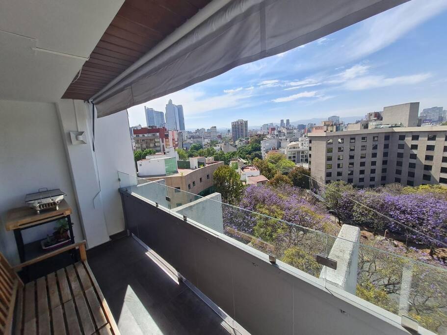 a balcony with a view of a city at Bright APT w/view near Reforma in Mexico City