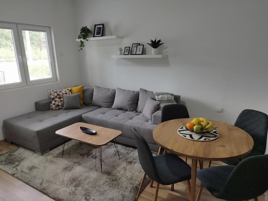 a living room with a couch and a table at Jaz Apartman in Bajina Bašta