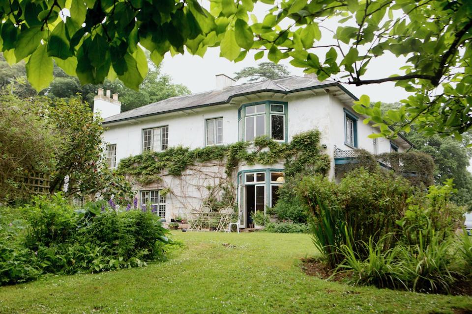 a large white house with a garden in front of it at ASHLEY COURT in Tiverton