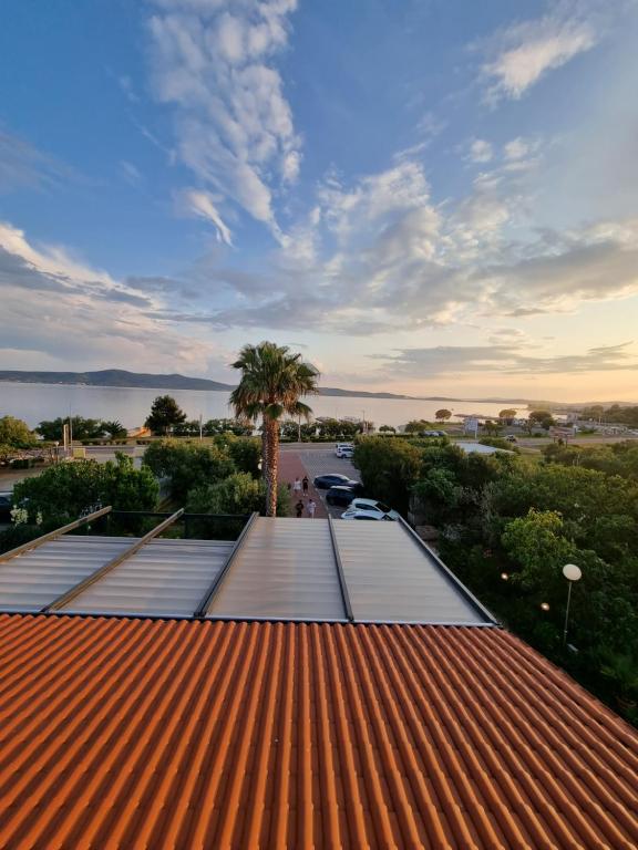 a view from the roof of a building with a palm tree at Villa Anton in Sukošan