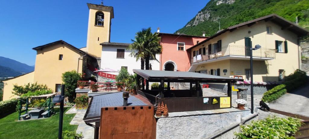 a building with a clock tower in front of it at B&B Monastero in Dubino