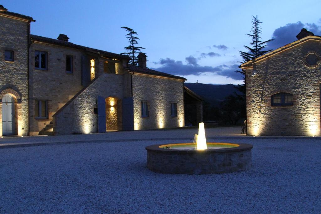 a large building with a candle in the middle of a courtyard at Collina d’Oro in Belforte del Chienti
