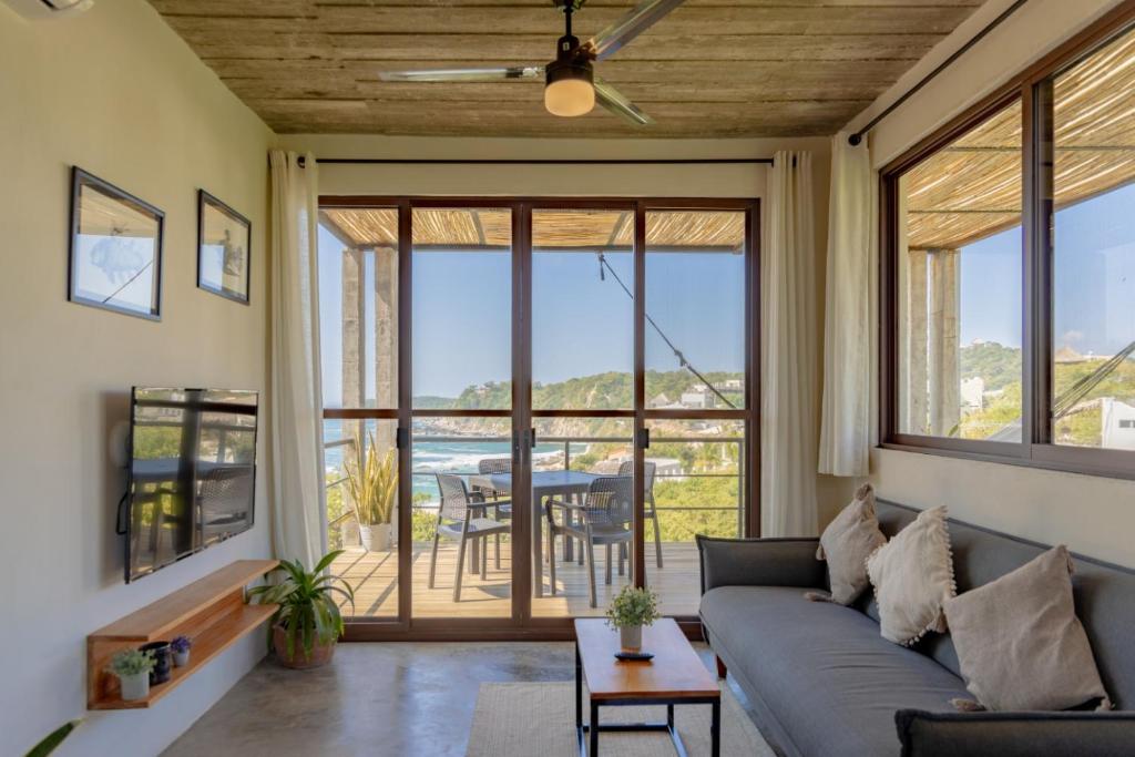 a living room with a couch and a table at Casa Mauna Boutique Hotel in Cuatunalco