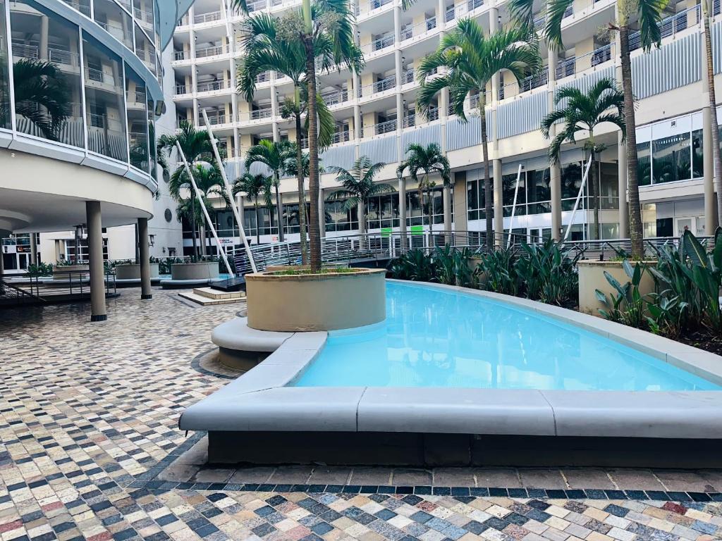 a large swimming pool in the middle of a building at The Sails One Bedroom Apartment in Durban