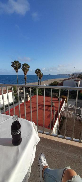 a person sitting at a table looking at the ocean at A vora mar in Benicarló