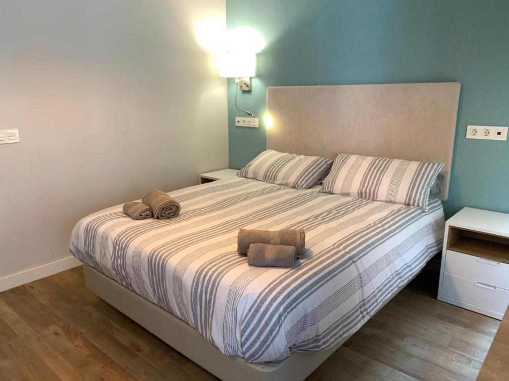 a bedroom with a large bed with two towels on it at Joyel de la Ribera in Aranda de Duero
