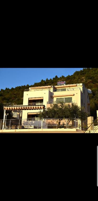 a building with a sign on the side of it at Apartmani Kate in Klek