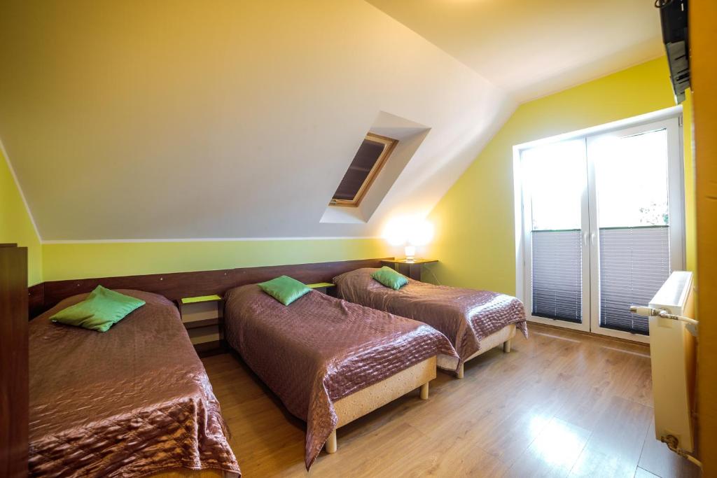 Łóżko lub łóżka w pokoju w obiekcie Villa ŁĄGI