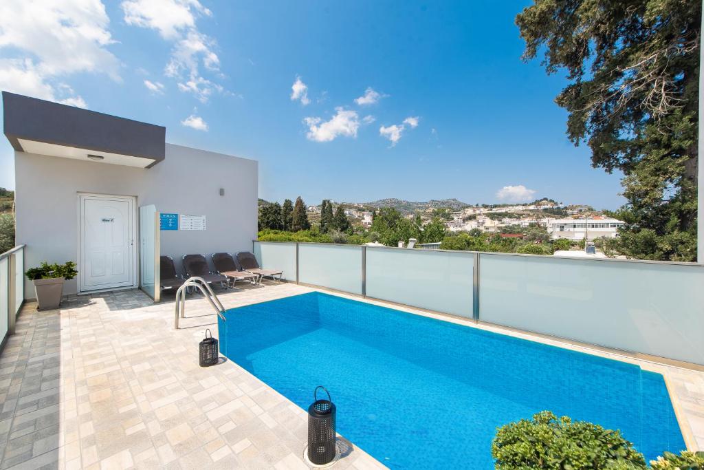 a swimming pool on the balcony of a house at Iliana Apartment in Afantou