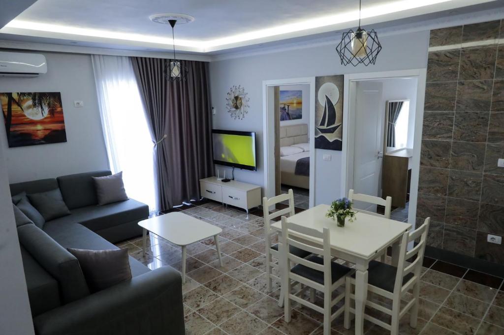 a living room with a couch and a table at Fishta apartments Q5 32 in Velipojë