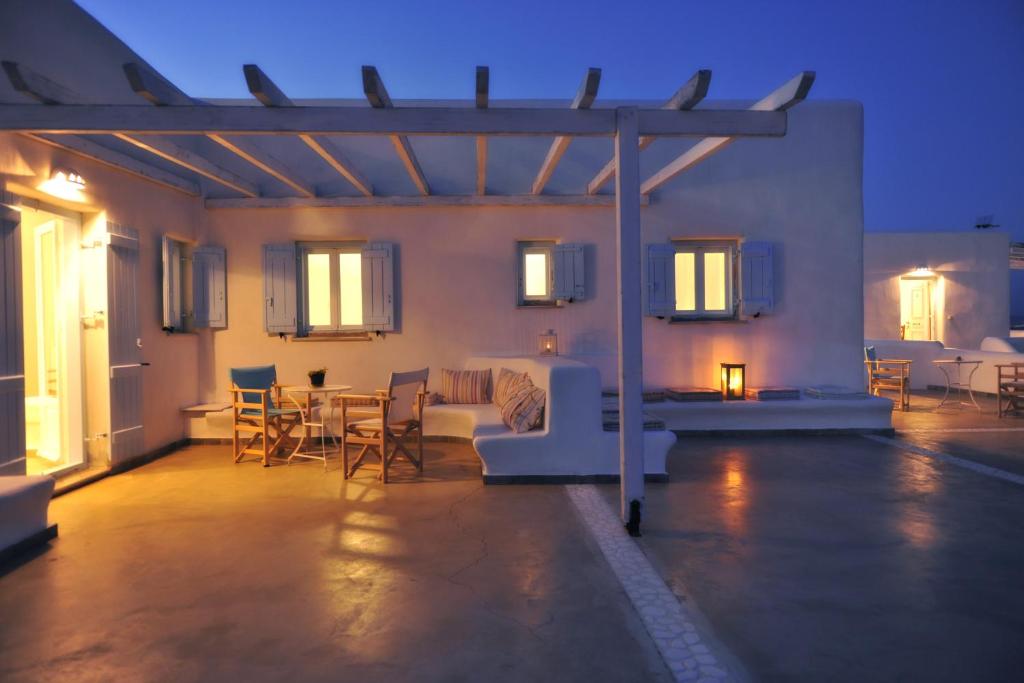 a living room with a couch and a table and chairs at Degaetas Resort in Antiparos