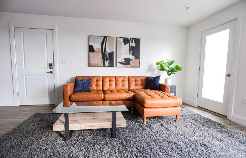 a living room with a brown leather couch and a coffee table at 1BR Luxury Apartment Peabody Unit 709 in Peabody