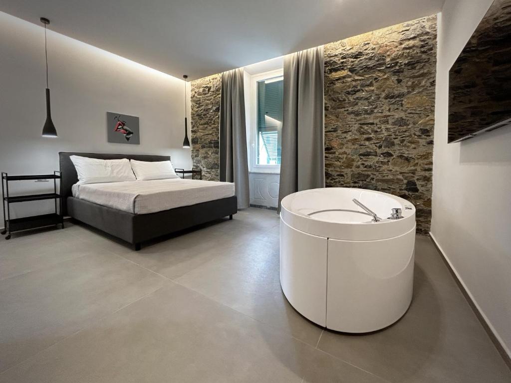 a bedroom with a bed and a tub in it at New Moon Rooms in La Spezia