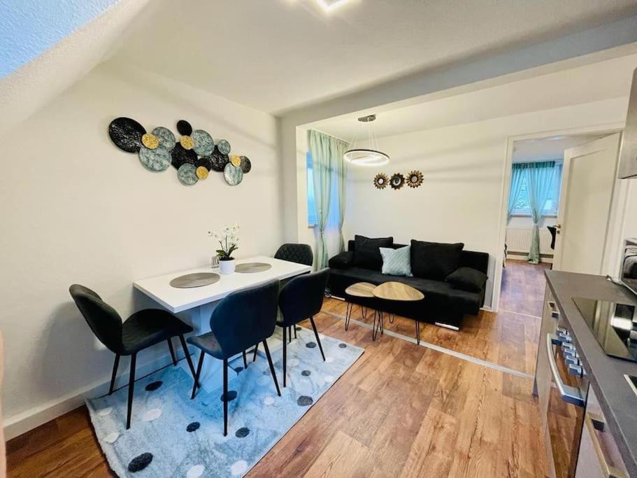 een woonkamer met een tafel en stoelen en een bank bij 3Zi-Central, Modern- The Sandcastle by SA-Grandeur in Friedrichshafen